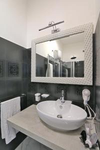 a bathroom with a white sink and a mirror at SOLIDEA BNB in Salerno
