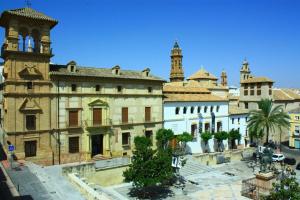 an old building with a clock tower in a city at Hotel Infante Antequera in Antequera