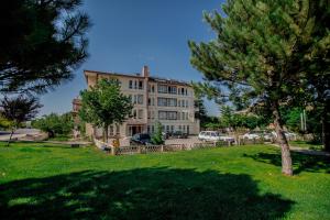a large building with a tree in front of it at Hotel Cappa in Ürgüp