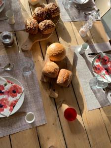 a wooden table topped with bread and a plate of food at #Glamping@De Verloren Sinjoor in Bladel +17 photos