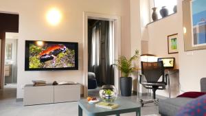 a living room with a tv on a wall at Casa25- Convenient location to Miland Centre & Como Lake! in Meda