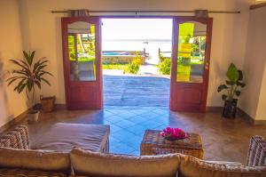 a living room with a door open to a patio at Vilancool Beach Resort in Vilanculos