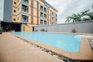 a swimming pool in front of a building at Iyara Hua Hin Lodge in Hua Hin