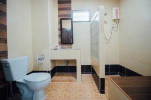 a bathroom with a toilet and a sink at Iyara Hua Hin Lodge in Hua Hin