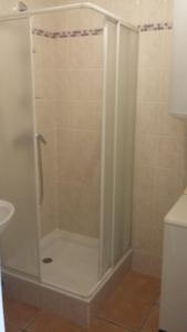 a shower with a glass door in a bathroom at Appartement dans propriété calme en pleine nature in Charbonnières-les-Bains +7 photos