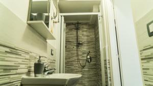 a bathroom with a shower with a sink and a shower at Il Nido del Gabbiano in Bagheria +4 photos
