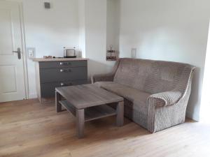 a living room with a chair and a coffee table at Ferienwohnung in Gadsdorf
