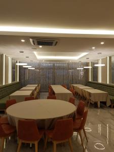 a dining room with tables and chairs and windows at BUSINESSPALAS DELUXE in Izmit