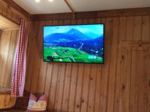a television hanging on a wall in a room at Apartment Lärchenstube in Mieders