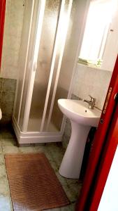 a bathroom with a white sink and a shower at La Casetta Mini Appartamento Centro Storico in Reggio Calabria