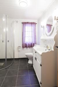 a bathroom with a sink and a toilet and a shower at Langlofonna in Stranda