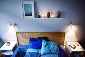 a bedroom with a bed with blue sheets and a mirror at Blue Apartament in Luboń