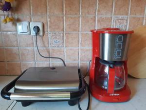 a red blender sitting on top of a counter at Dina in Palaia Fokaia