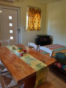 a wooden table with a plate of fruit on it at Dina in Palaia Fokaia +38 photos