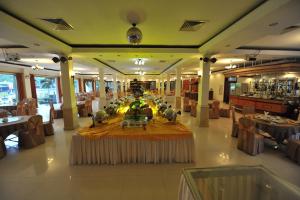 a restaurant with a table in the middle of a room at Saigon Kimlien Resort Cualo in Cửa Lò