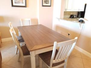 a wooden table and chairs in a kitchen at Surf Club I, 1405 Condo in Palm Coast
