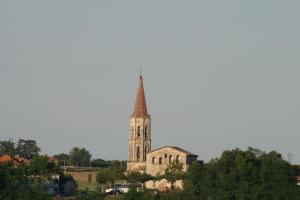 an old church with a steeple on a hill at Gîte Rozies Dunes 4 p in Dunes +3 photos