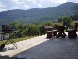 a patio with a view of a mountain at Villa Usivak for green quiet holiday near Sarajevo in Sarajevo