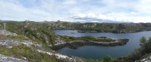 an aerial view of a lake in the mountains at Achmelvich View self catering in Lochinver