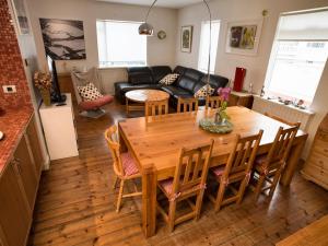 a kitchen and living room with a wooden table and chairs at Town House close to Center in Reykjavík