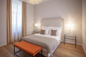 a bedroom with a large bed and a chandelier at Little King U Malvaze in Prague