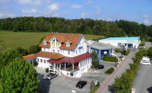 an aerial view of a large white building with a store at Donau-Hotel in Sinzing