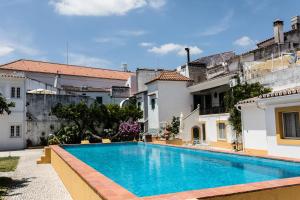 a swimming pool in a villa with a building at Vintage Guest House - Casa do Escritor in Évora