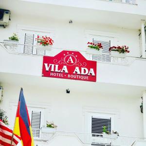 a sign on the side of a building with a flag at Vila Ada Hotel in Tirana