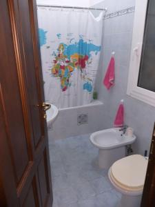 a bathroom with a toilet and a sink and a shower curtain at Il giardino di Peo in Bogliasco +34 photos