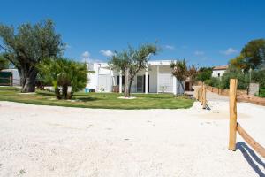 a house on the beach with trees in front of it at Domo de Maria in Orosei