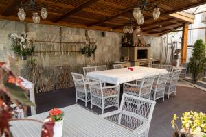 a white table and chairs on a patio at Diplomat Club Hotel in Chişinău