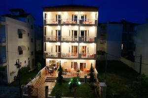 a large white building with a balcony at night at Marie Claire Studios in Olympic Beach