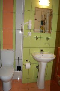 a bathroom with a toilet and a sink at Marie Claire Studios in Olympic Beach