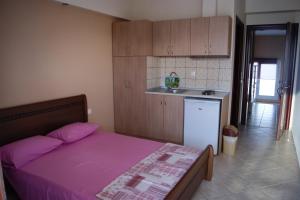 a small bedroom with a bed and a kitchen at Marie Claire Studios in Olympic Beach +76 photos
