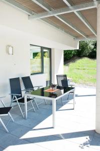 two laptops sitting on a table on a patio at Ferienwohnung Wohlfühlen in Pfunds
