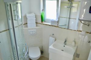 a bathroom with a sink and a toilet and a mirror at Apartmani Pax in Pakoštane +25 photos