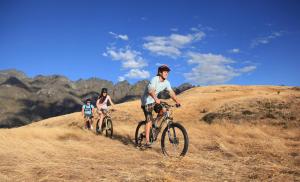 a group of people riding bikes on a hill at Amber Lodge in Queenstown