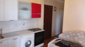 a kitchen with a washing machine and red cabinets at B&B Dimora Marchese in Marina di Camerota +46 photos