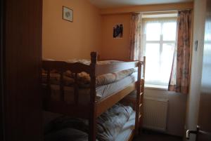 a bedroom with two bunk beds and a window at Gut Dankerode in Dankerode