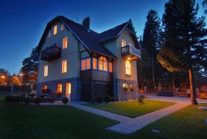 a large house at night with its lights on at Villa Grace - wypoczynek bez dzieci in Szklarska Poręba
