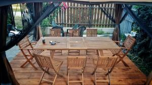 a wooden table and chairs on a wooden deck at Iorga's House in Eforie Nord