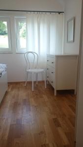 a bedroom with a chair and a desk at Domek Gościnny Dyziówka in Szczyrk