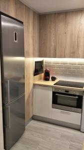 a kitchen with a stainless steel refrigerator and a stove at MUSU in Estella