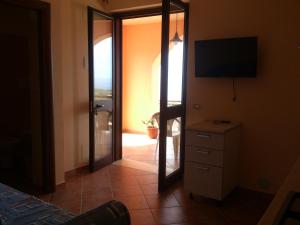 a bedroom with a mirror and a dresser with a television at B&B Dimora Marchese in Marina di Camerota