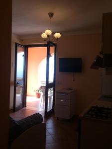 a living room with a mirror and a television at B&B Dimora Marchese in Marina di Camerota