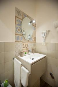 a bathroom with a sink and a mirror at Siracusa Houses K&S in Siracusa +45 photos