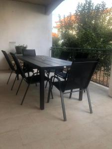 a black table and chairs on a patio at Apartman Dukić in Okrug Gornji