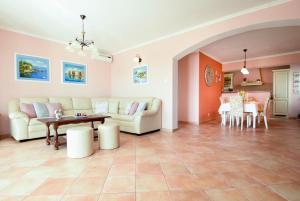 a living room with a couch and a table at Villa Sun in Čilipi