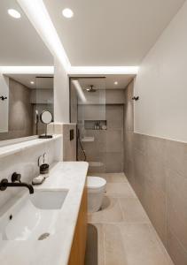 a bathroom with a sink and a toilet at ELADIA Suites in Neos Marmaras