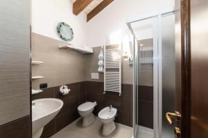 a bathroom with a toilet sink and a shower at Il Viaggio in Diano Marina +55 photos
